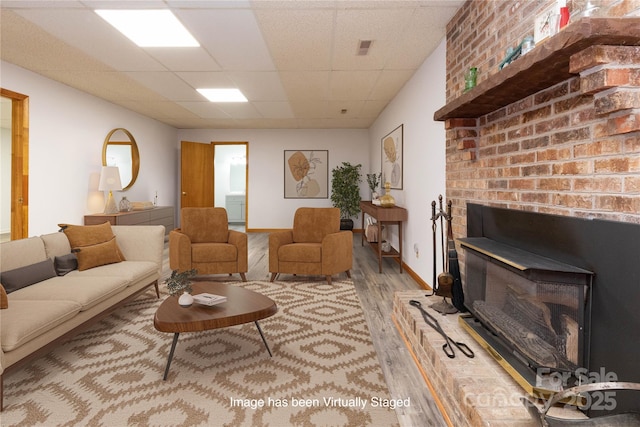 109 Wilkie Way, Fletcher, NC 28732 - living area featuring wood finished floors, a drop ceiling, a wood stove, and baseboards