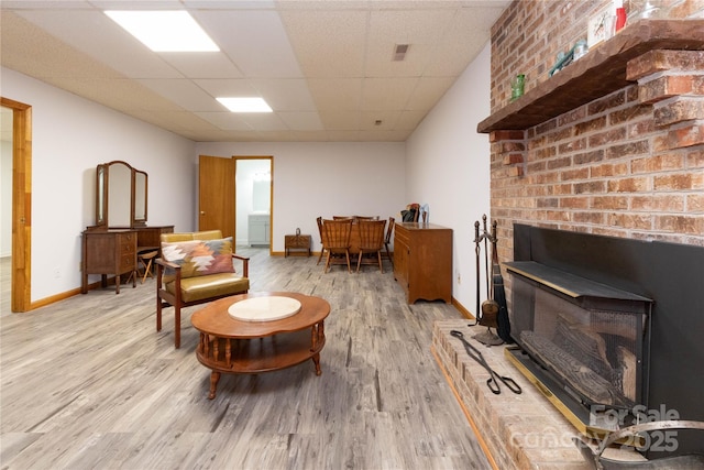 109 Wilkie Way, Fletcher, NC 28732 - sitting room with wood finished floors, a drop ceiling, baseboards, and a wood stove