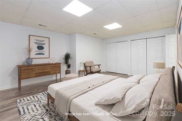 109 Wilkie Way, Fletcher, NC 28732 - bedroom featuring a drop ceiling, multiple closets, wood finished floors, and baseboards