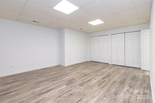 109 Wilkie Way, Fletcher, NC 28732 - unfurnished bedroom featuring a drop ceiling, wood finished floors, two closets, and baseboards