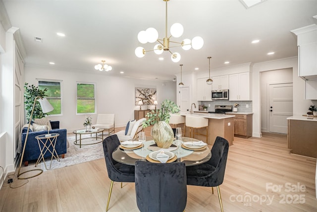 4547 Kings Ct, Hickory, NC 28602 - dining space featuring ornamental molding, light wood-style flooring, recessed lighting, and a chandelier