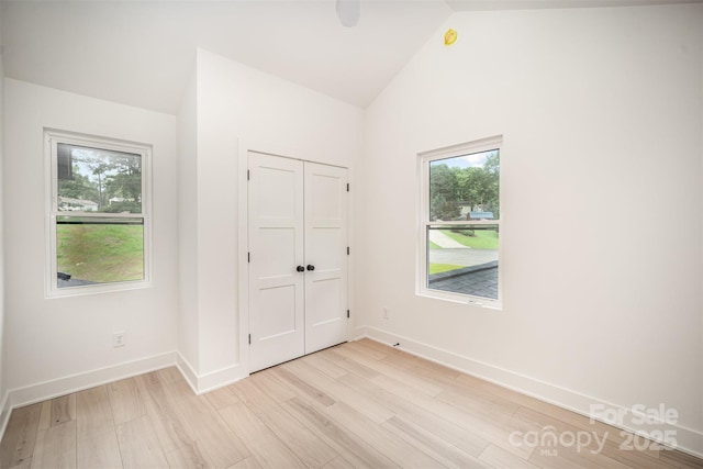4547 Kings Ct, Hickory, NC 28602 - unfurnished bedroom with light wood-style flooring, vaulted ceiling, a closet, and ceiling fan