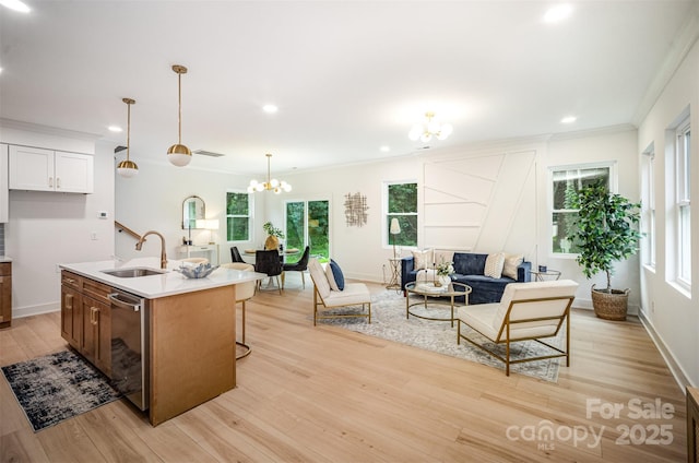 4547 Kings Ct, Hickory, NC 28602 - kitchen with stainless steel dishwasher, a chandelier, ornamental molding, light wood-type flooring, and open floor plan