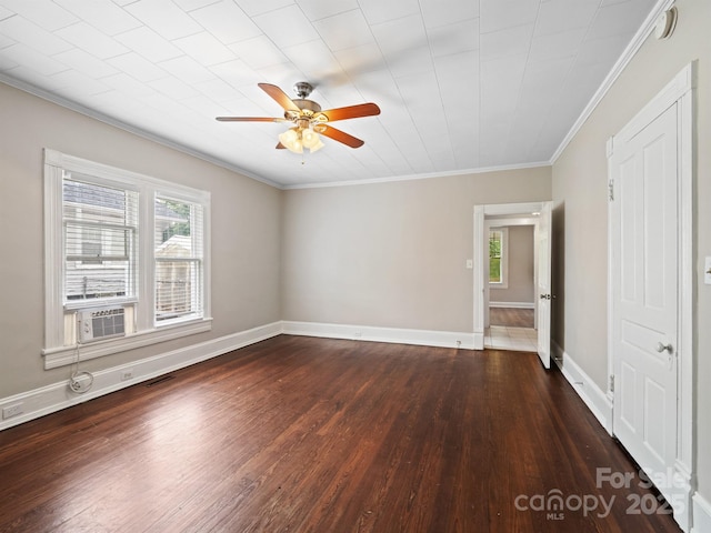 unfurnished bedroom with dark wood-style flooring, crown molding, cooling unit, baseboards, and a ceiling fan