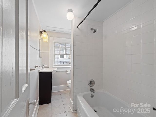bathroom featuring tile patterned flooring, toilet, washtub / shower combination, vanity, and baseboards