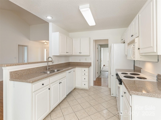 14 Stonehollow Rd, Fletcher, NC 28732 - kitchen featuring a sink, white appliances, a peninsula, white cabinets, and a textured ceiling