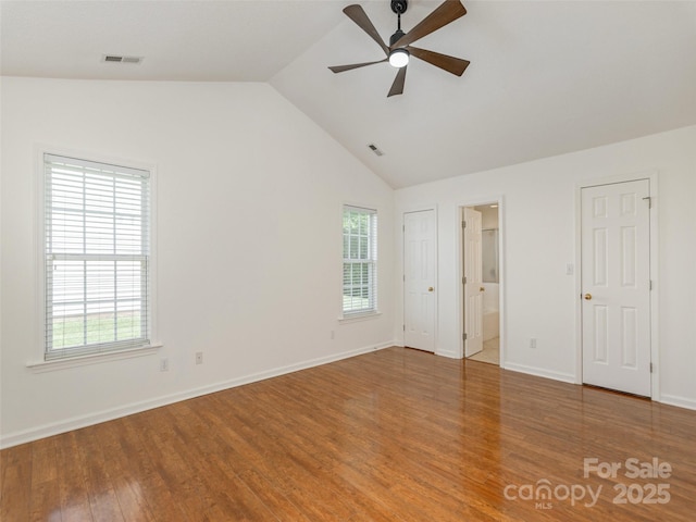 14 Stonehollow Rd, Fletcher, NC 28732 - unfurnished bedroom with vaulted ceiling, wood finished floors, baseboards, and ensuite bathroom