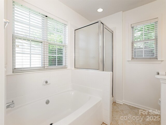 14 Stonehollow Rd, Fletcher, NC 28732 - bathroom with a bath, a stall shower, tile patterned flooring, toilet, and baseboards