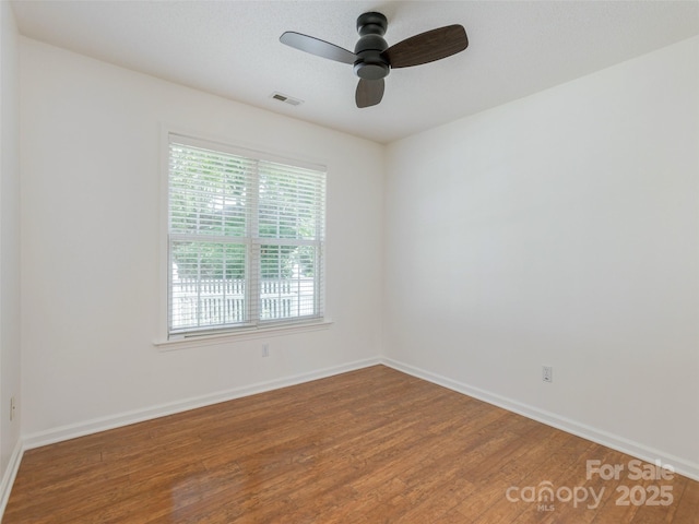14 Stonehollow Rd, Fletcher, NC 28732 - unfurnished room with healthy amount of natural light, wood finished floors, a ceiling fan, and baseboards