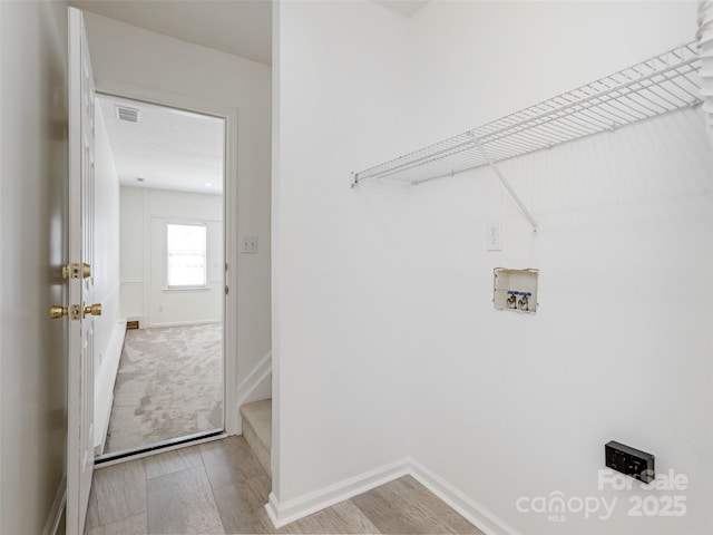 14 Stonehollow Rd, Fletcher, NC 28732 - laundry area with electric dryer hookup, washer hookup, baseboards, and wood finished floors