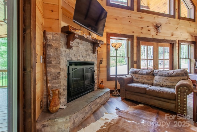 91 Riverview Dr, Robbinsville, NC 28771 - living room with wooden walls, wood finished floors, and a fireplace