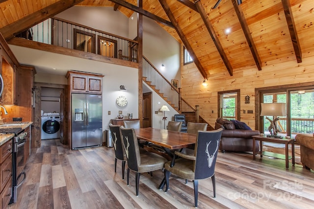 91 Riverview Dr, Robbinsville, NC 28771 - dining area with high vaulted ceiling, stairs, wooden ceiling, wood walls, and wood finished floors