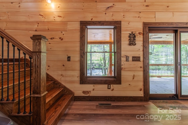 91 Riverview Dr, Robbinsville, NC 28771 - entryway featuring wood finished floors, healthy amount of natural light, wood walls, and stairs