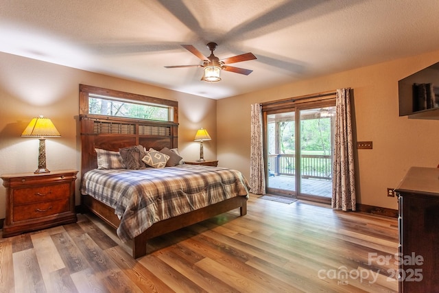 91 Riverview Dr, Robbinsville, NC 28771 - bedroom featuring access to exterior, multiple windows, and wood finished floors