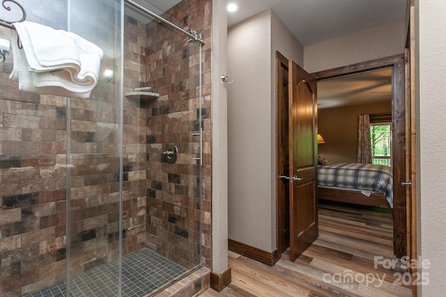 91 Riverview Dr, Robbinsville, NC 28771 - ensuite bathroom with wood finished floors, a shower stall, and a textured wall