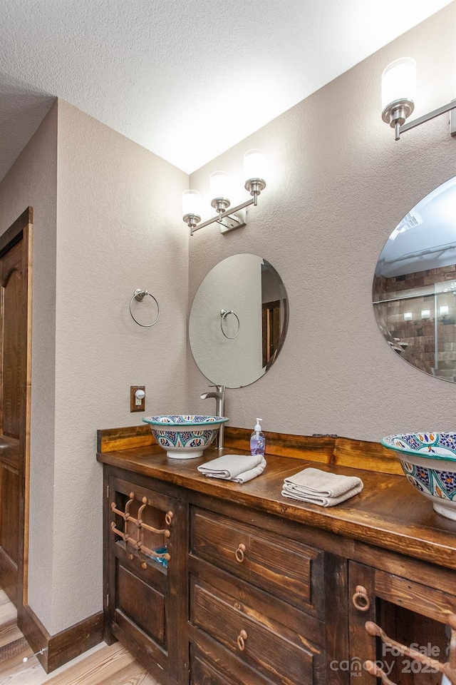 91 Riverview Dr, Robbinsville, NC 28771 - bathroom with wood finished floors, vanity, and a textured wall