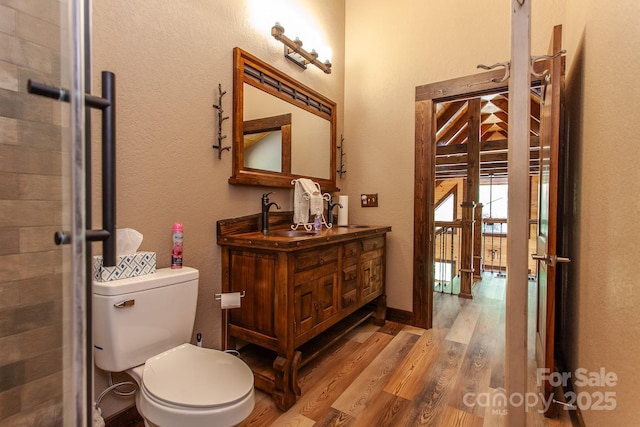 91 Riverview Dr, Robbinsville, NC 28771 - bathroom with wood finished floors, toilet, vanity, and tiled shower
