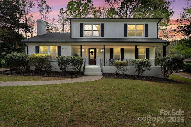 5910 Grosner Pl, Charlotte, NC 28211 - view of front of property with a porch, a chimney, and a front yard