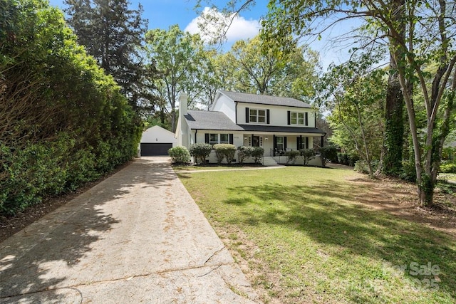 5910 Grosner Pl, Charlotte, NC 28211 - traditional-style home featuring covered porch, an outbuilding, a front lawn, a chimney, and a garage