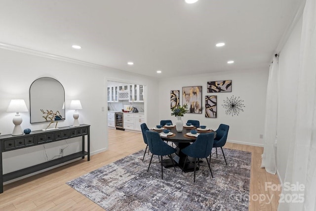5910 Grosner Pl, Charlotte, NC 28211 - dining area featuring ornamental molding, beverage cooler, recessed lighting, light wood-style flooring, and baseboards
