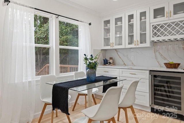 5910 Grosner Pl, Charlotte, NC 28211 - indoor dry bar featuring wine cooler, backsplash, crown molding, and light wood-style floors