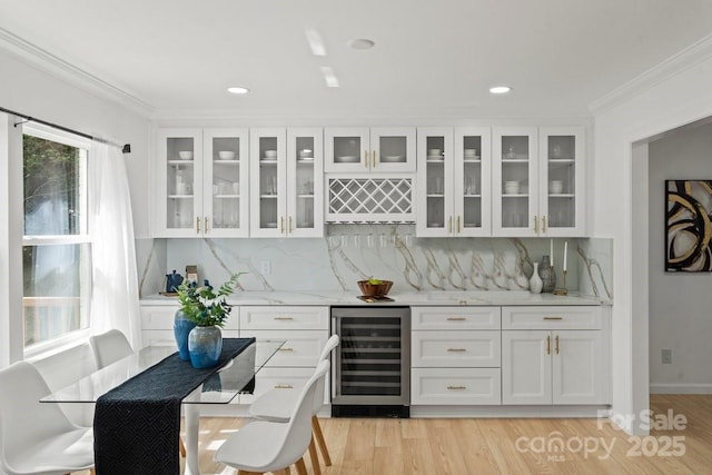 5910 Grosner Pl, Charlotte, NC 28211 - indoor bar featuring beverage cooler, ornamental molding, decorative backsplash, light wood finished floors, and recessed lighting