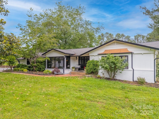 64 Persimmon Hill Dr Unit 4, Columbus, NC 28722 - ranch-style home featuring a front yard, a sunroom, and a shingled roof