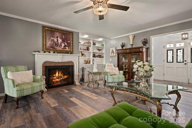 64 Persimmon Hill Dr Unit 4, Columbus, NC 28722 - living room featuring ornamental molding, a warm lit fireplace, a ceiling fan, wood finished floors, and built in features