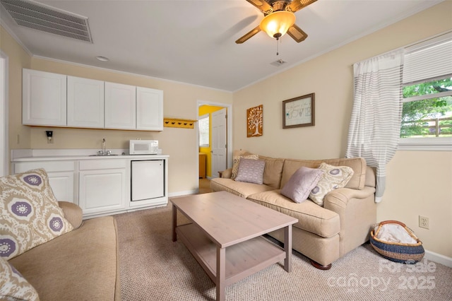 64 Persimmon Hill Dr Unit 4, Columbus, NC 28722 - living room featuring crown molding, light carpet, ceiling fan, and baseboards