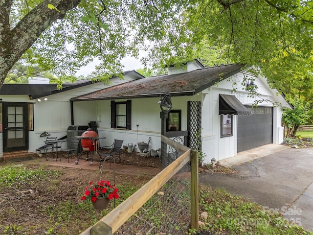 64 Persimmon Hill Dr Unit 4, Columbus, NC 28722 - view of front facade with a chimney, a garage, and driveway