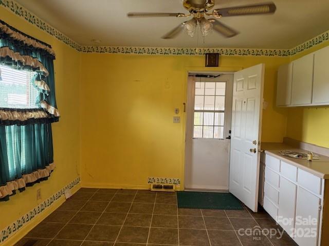 2165 Mccraw Rd, Mooresboro, NC 28114 - doorway to outside with healthy amount of natural light, dark tile patterned flooring, ceiling fan, and baseboards