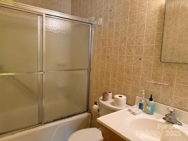 2165 Mccraw Rd, Mooresboro, NC 28114 - bathroom with combined bath / shower with glass door, vanity, toilet, and tile walls