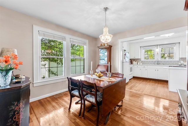 204 S Elm St, Cherryville, NC 28021 - dining area with light wood-style flooring, a chandelier, and plenty of natural light