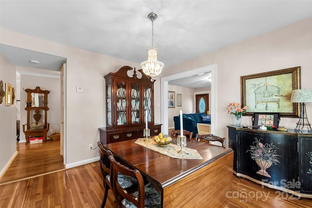204 S Elm St, Cherryville, NC 28021 - dining room featuring a chandelier, wood finished floors, and baseboards