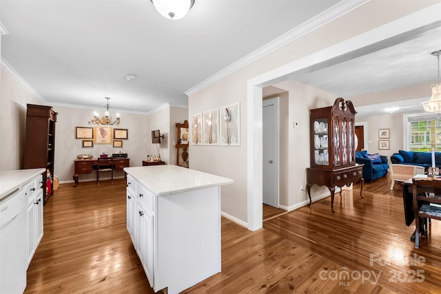 204 S Elm St, Cherryville, NC 28021 - kitchen featuring a chandelier, light countertops, light wood-style floors, white cabinetry, and ornamental molding