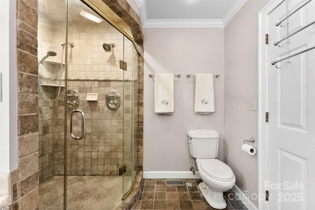 204 S Elm St, Cherryville, NC 28021 - bathroom featuring crown molding, baseboards, a shower stall, and toilet