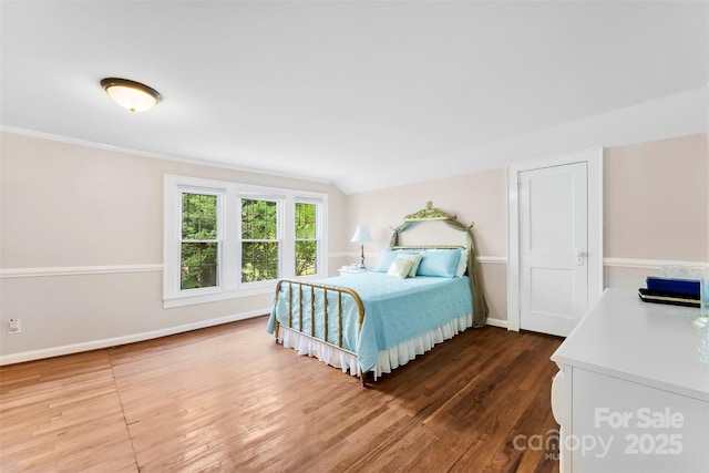 204 S Elm St, Cherryville, NC 28021 - bedroom with wood finished floors, vaulted ceiling, and baseboards