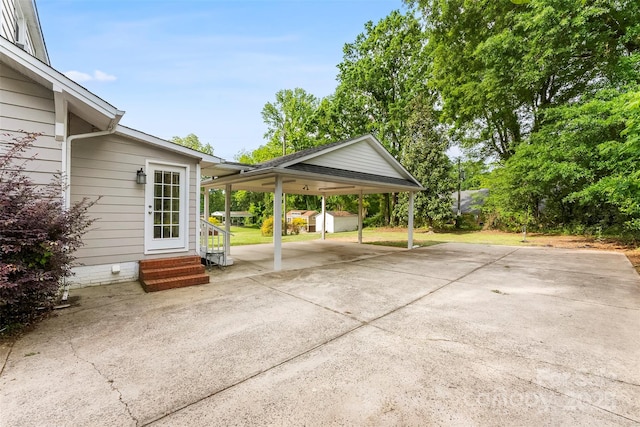 204 S Elm St, Cherryville, NC 28021 - view of patio / terrace featuring a storage shed, an outdoor structure, a carport, entry steps, and concrete driveway