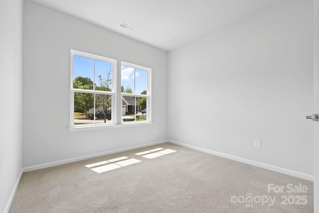 spare room with carpet flooring and baseboards