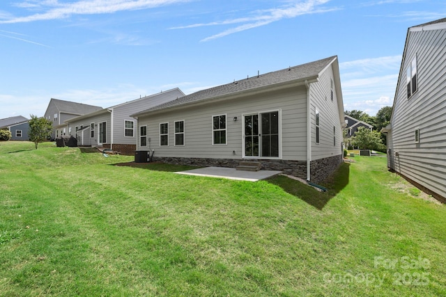 rear view of property featuring a patio area, a lawn, central AC, and entry steps