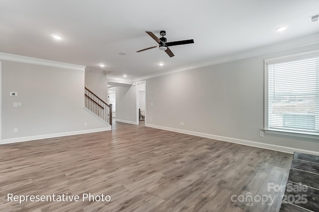 unfurnished living room with crown molding, stairs, ceiling fan, recessed lighting, and wood finished floors