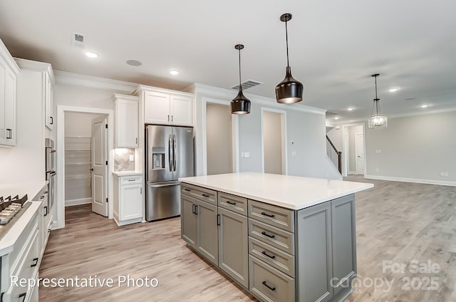 kitchen featuring appliances with stainless steel finishes, crown molding, gray cabinets, white cabinets, and light countertops