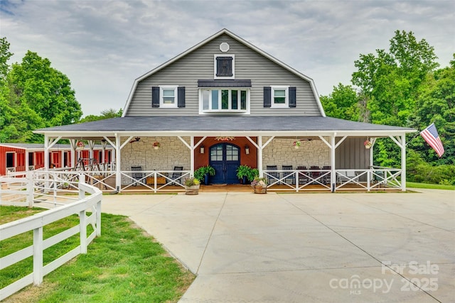 3091 Old Meeting House Rd, Sharon, SC 29742 - view of front of house featuring a gambrel roof, covered porch, board and batten siding, and stone siding