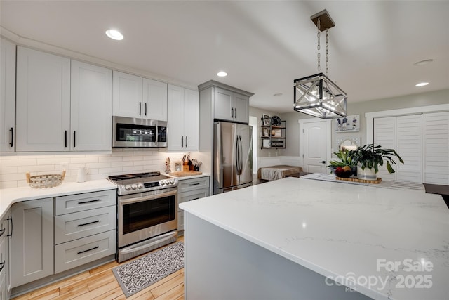 3091 Old Meeting House Rd, Sharon, SC 29742 - kitchen with appliances with stainless steel finishes, gray cabinetry, decorative backsplash, light stone countertops, and recessed lighting