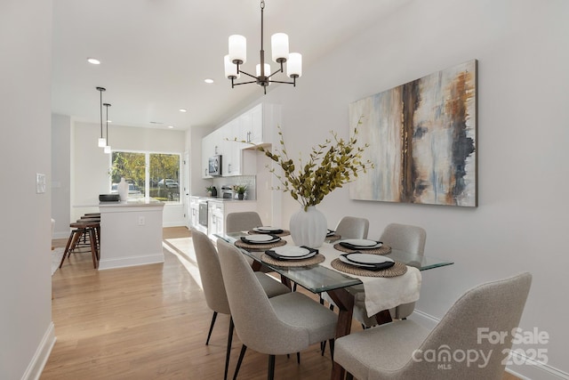dining space featuring light wood-type flooring, a chandelier, recessed lighting, and baseboards