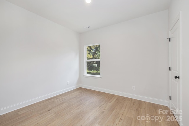 spare room featuring baseboards, light wood finished floors, and recessed lighting