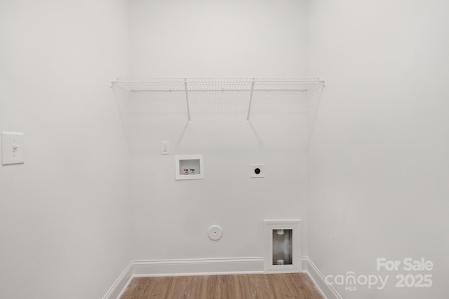 washroom with hookup for a washing machine, hookup for a gas dryer, electric dryer hookup, wood finished floors, and baseboards