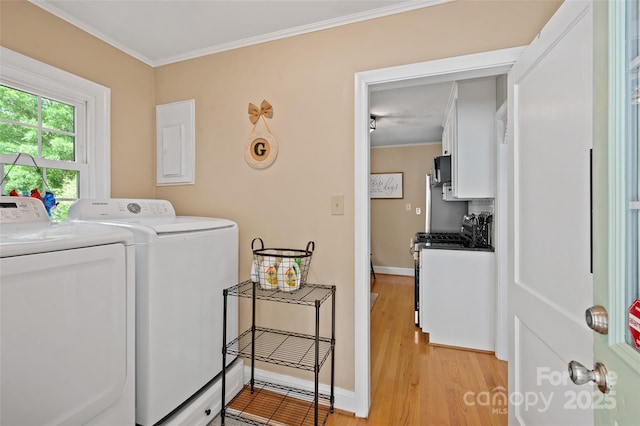 laundry room featuring washing machine and dryer, light wood-type flooring, crown molding, and baseboards