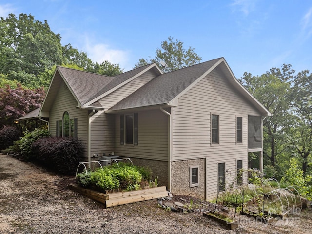 273 Bluebird Rd, Lake Lure, NC 28746 - view of home's exterior featuring a vegetable garden and a shingled roof