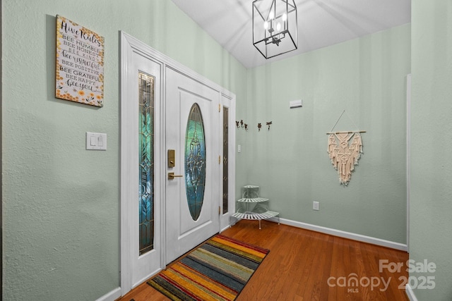 273 Bluebird Rd, Lake Lure, NC 28746 - foyer featuring wood finished floors, baseboards, and a chandelier